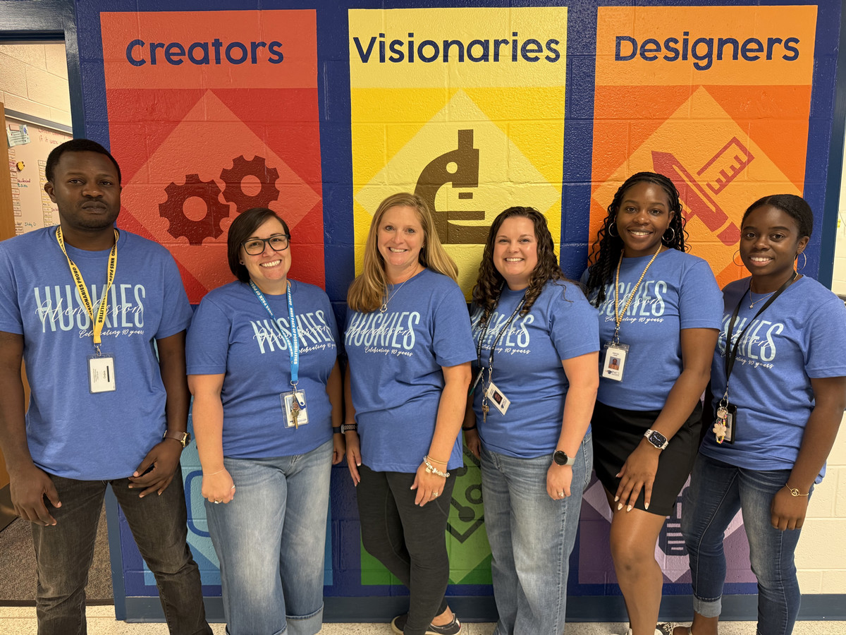 Fourth grade team smiling and standing next to eachother.